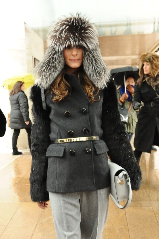 Olivia Palermo beats the bad winter weather with a fur lined hat and black jacket at a New York Fashion Week event
